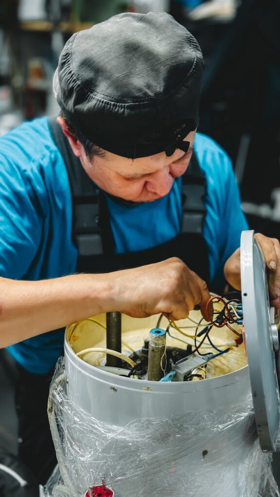 Skilled technician working on machinery maintenance, focused and detailed.